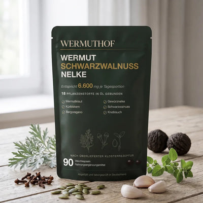 Wermut, Nelken, Kürbiskerne und Knoblauch neben der Packung der Kräuterkur
